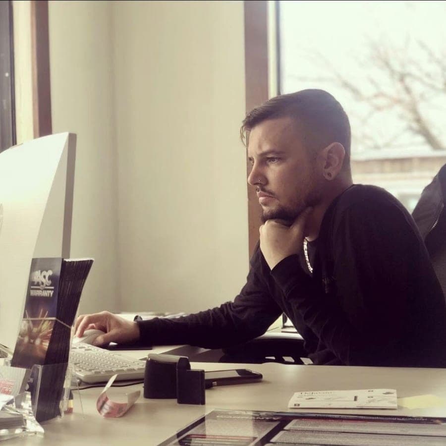 Ryan, owner of RydeTime Auto, at work in the dealership office